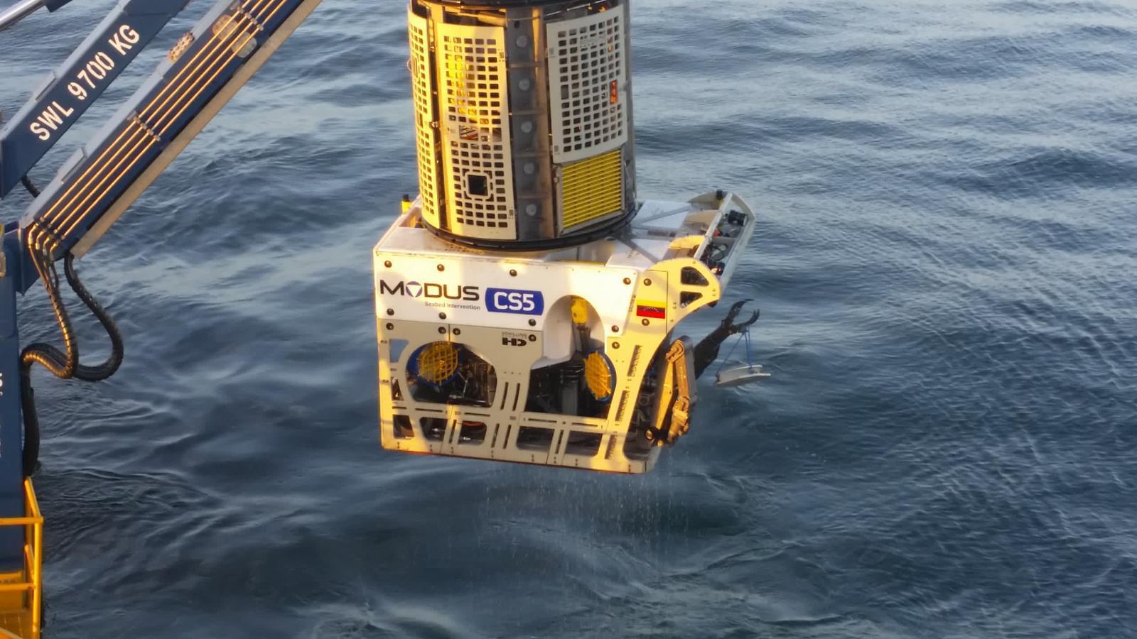 ROV being deployed from a vessel at sunrise