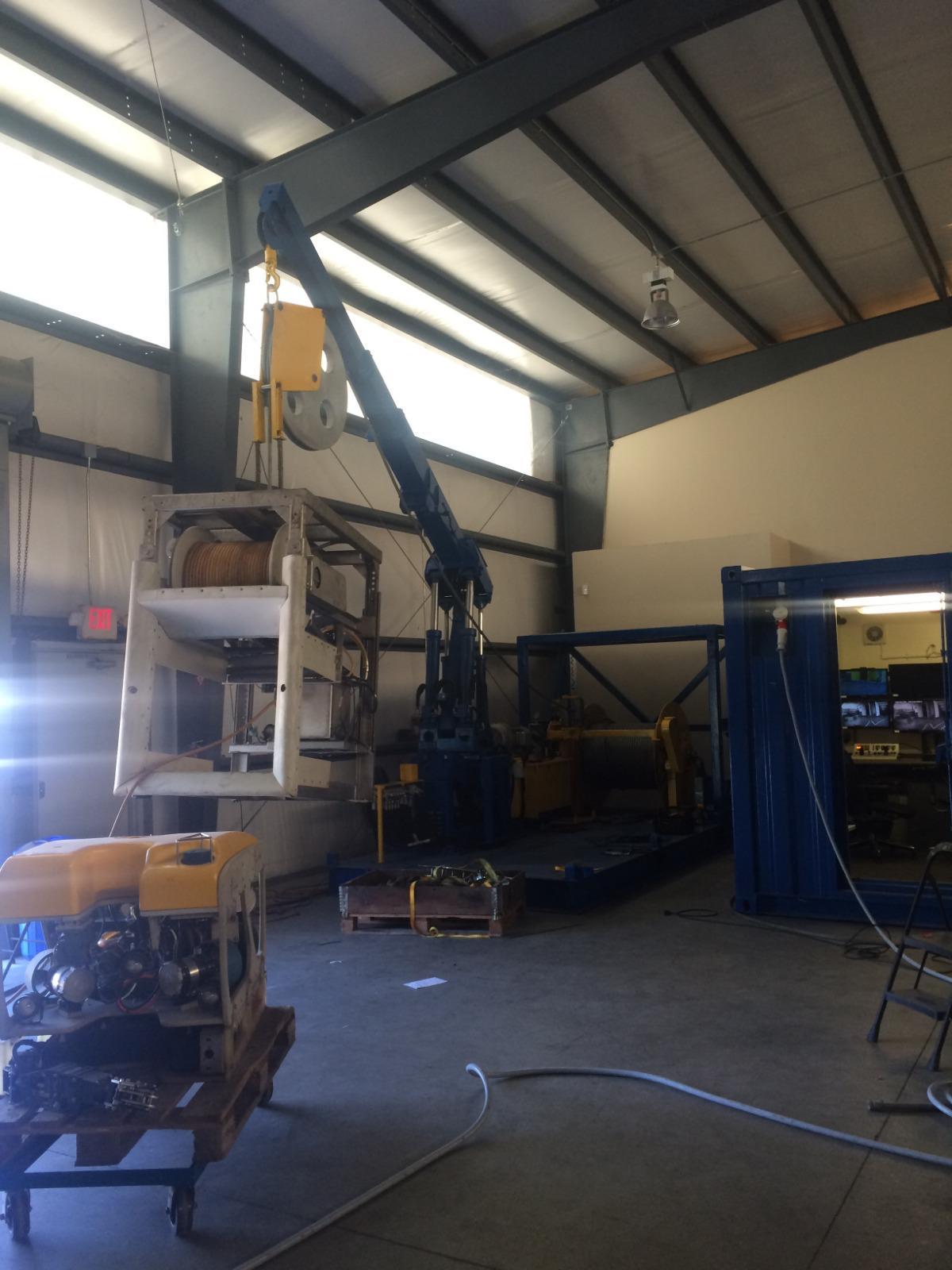 ROV workshop with crane lifting subsea cage