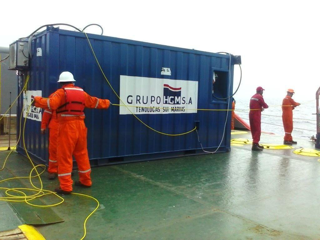 Offshore crew working beside HGM operations container
